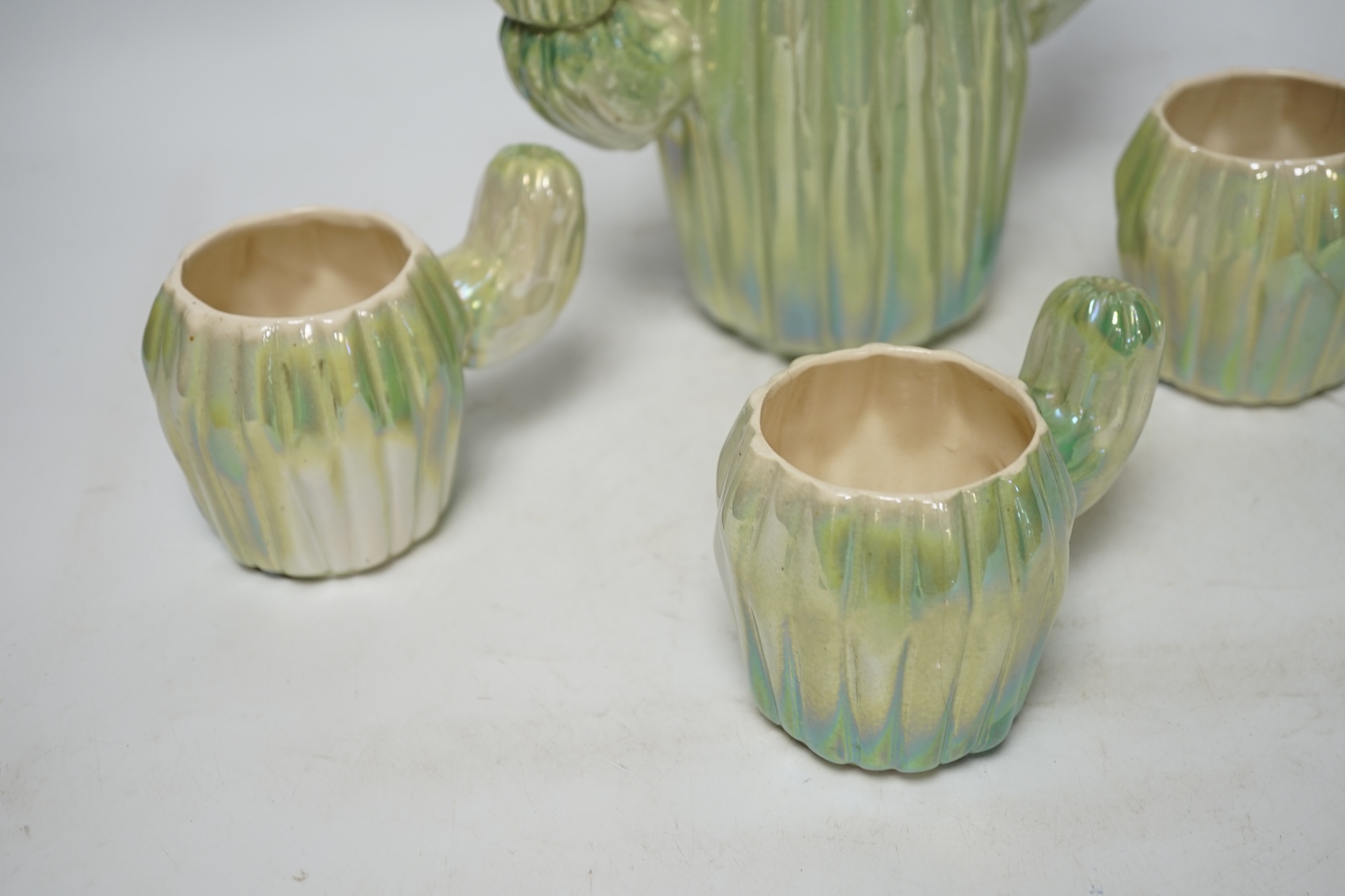 From the Studio of Fred Cuming. A cactus design part coffee set, largest 24cm high. Condition - fair, one cup broken and repaired
